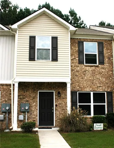 View of front facade featuring brick siding and a front lawn
