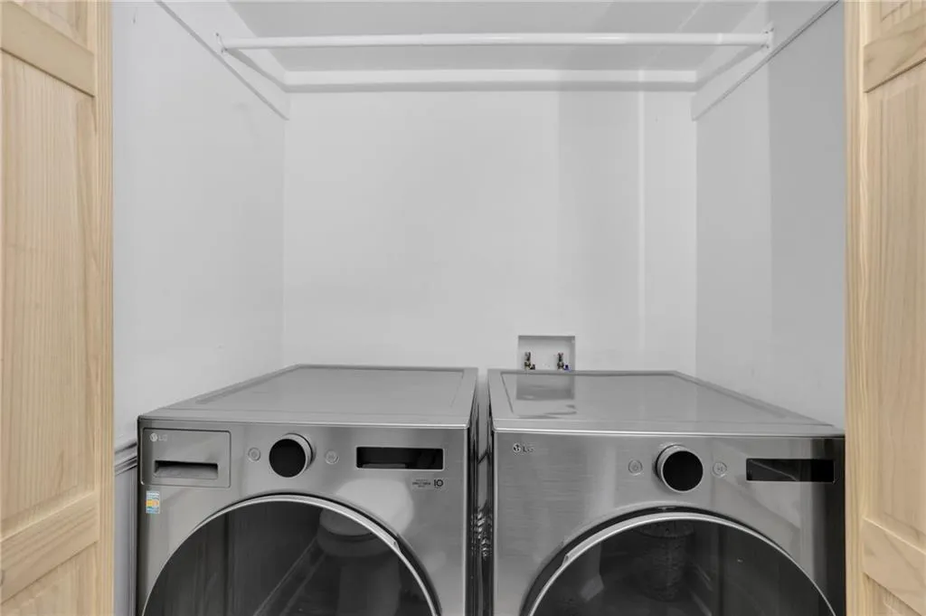 Washroom featuring washing machine and dryer