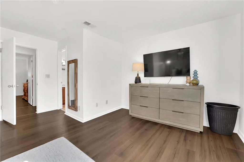 Bedroom featuring dark wood-style flooring