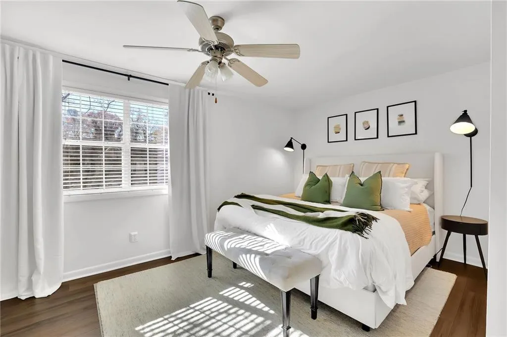 Bedroom featuring dark wood-style flooring and a ceiling fan