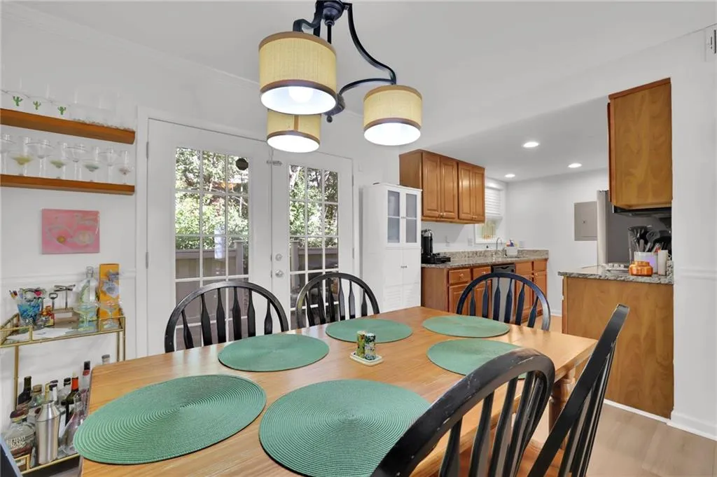 Dining room featuring french doors, recessed lighting, and light wood finished floors