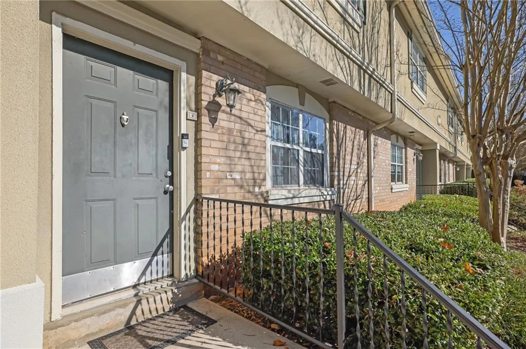 Doorway to property featuring brick siding