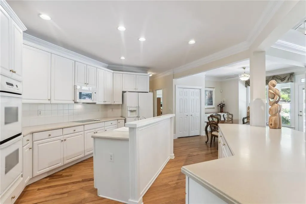 795 Spalding Heights Drive~ S P A C I O U S Kitchen features plenty of white cabinetry, double ovens, glass cooktop, Corian countertops, deep Ceramic sink and overlooks the Family Room and Breakfast room.