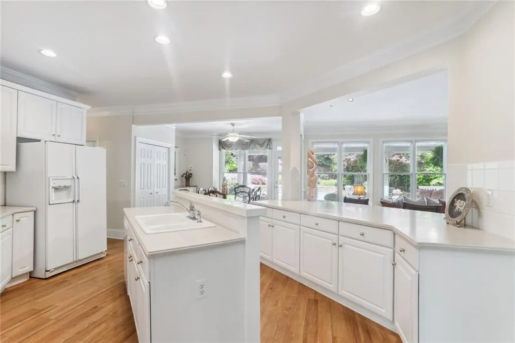 795 Spalding Heights Drive~ An alternate view of the Family room. Conveniently located in the center of the main level, the open kitchen allows for casual entertainment, whether the party is in the house or by the pool!