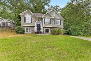 Charming two-story colonial featuring a brick and siding exterior with peaked rooflines and gabled dormers
