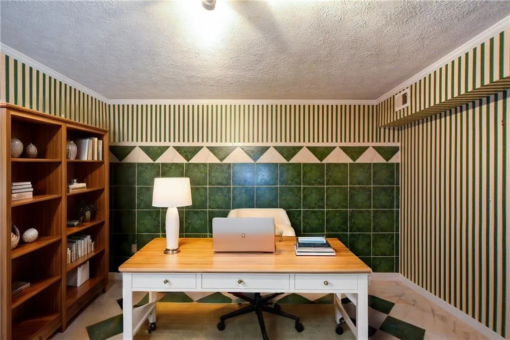 Office with ornamental molding, tile walls, and a textured ceiling