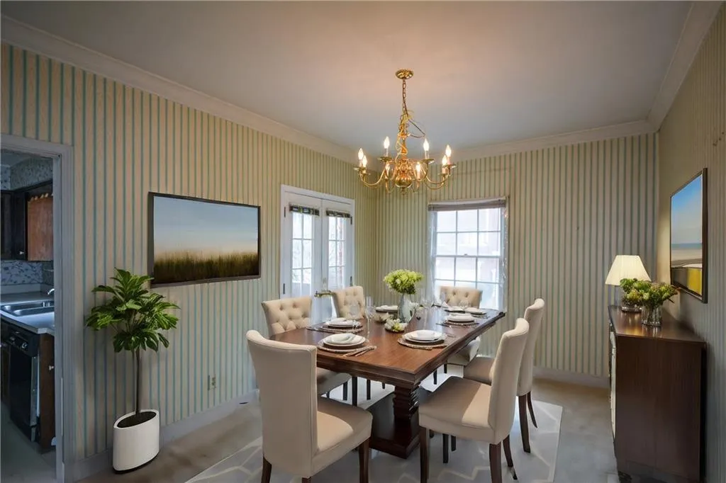 Dining room featuring an inviting chandelier, ornamental molding, and sink