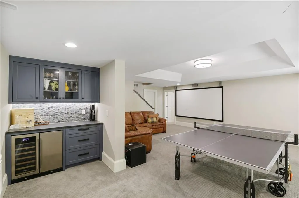 Terrace level offers a beverage bar, game area and family room.