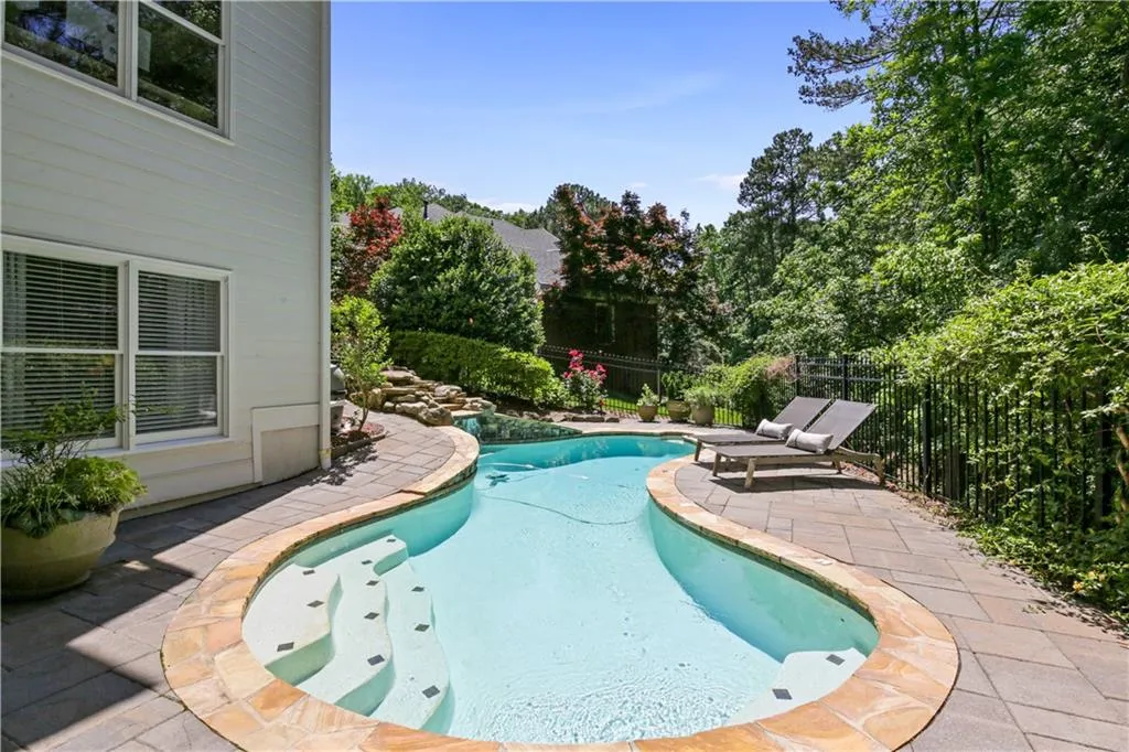 Heated, salt water pool with water fountain.