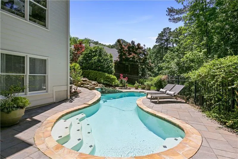 Heated, salt water pool with water fountain.