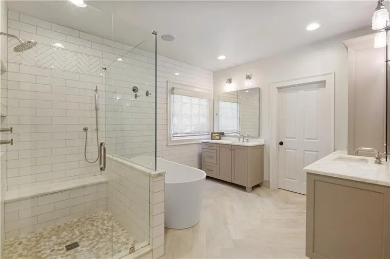 Renovated spa-like Primary Bath with his and her vanity, shower and soaking tub.