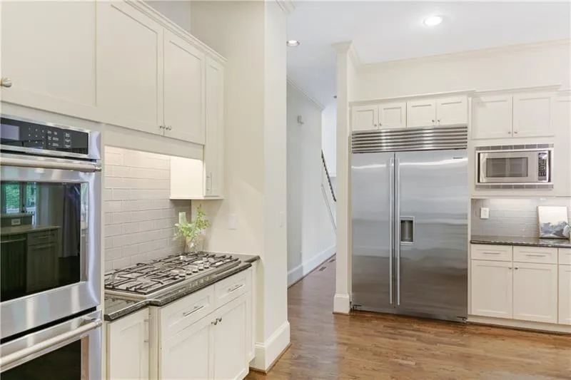Double ovens, gas cook top and stainless appliances.