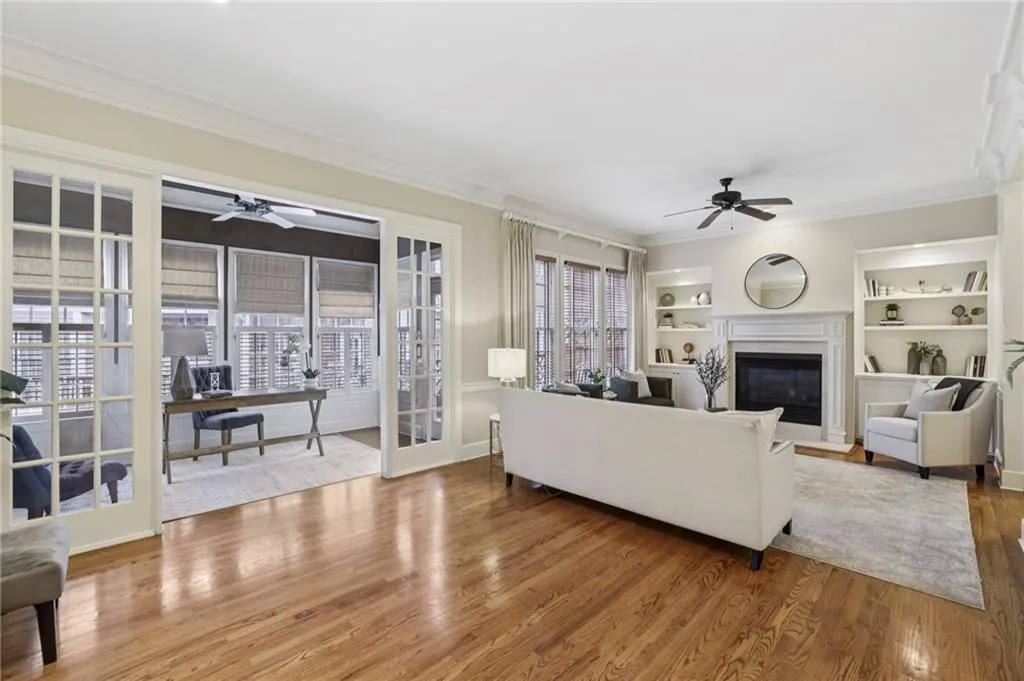 Beautiful fixed glass doors divide the living room from the sunroom