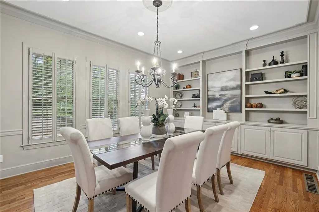 Large dining room with French pocket doors, built-in cabinets and plantation shutters