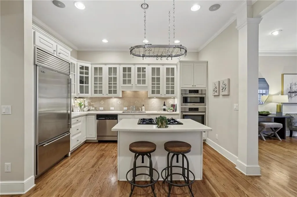 Wonderful kitchen with center island with pot rack and stainless appliances