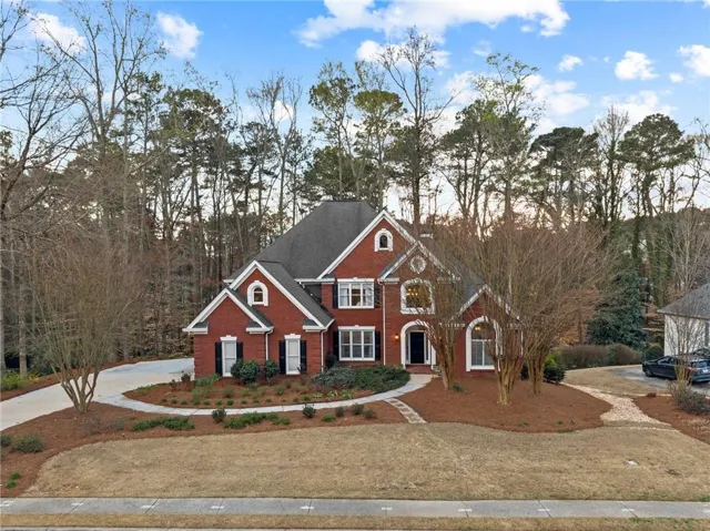 Brick exterior with black shutters and white trim