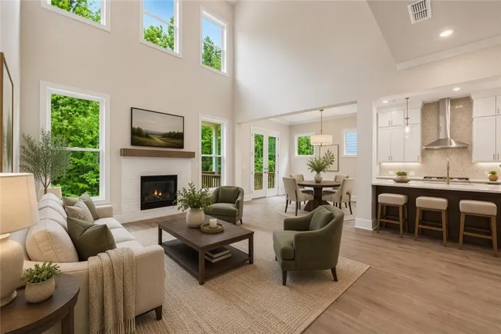Welcome to the Calhoun plan on homesite 128! The Calhoun features a 2 story family room and large windows to let in so much natural light. This picture has been virtually staged.