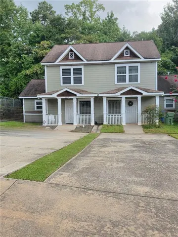 Two-story exterior with light green siding and white trim