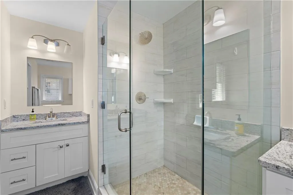 Bathroom featuring vanity and an enclosed shower