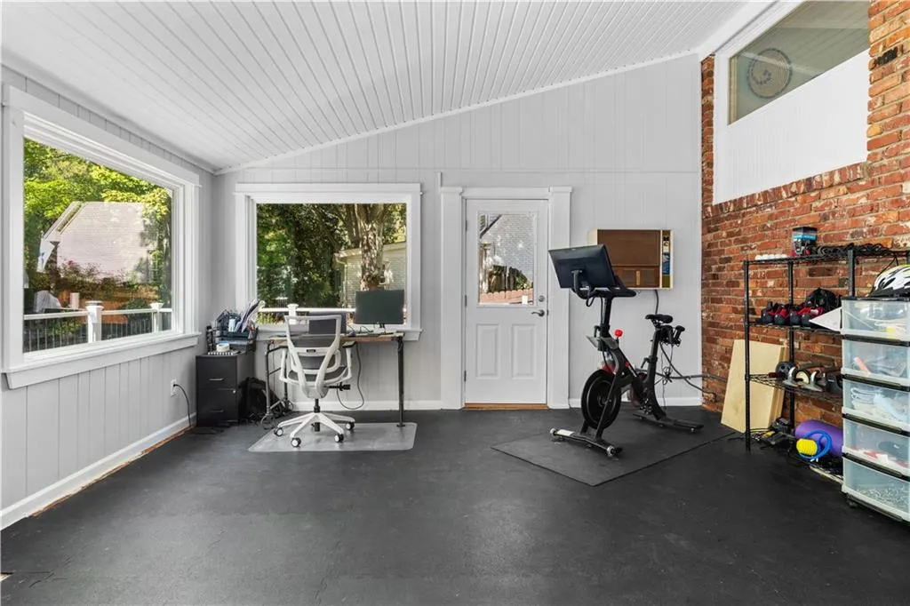 Workout room with lofted ceiling