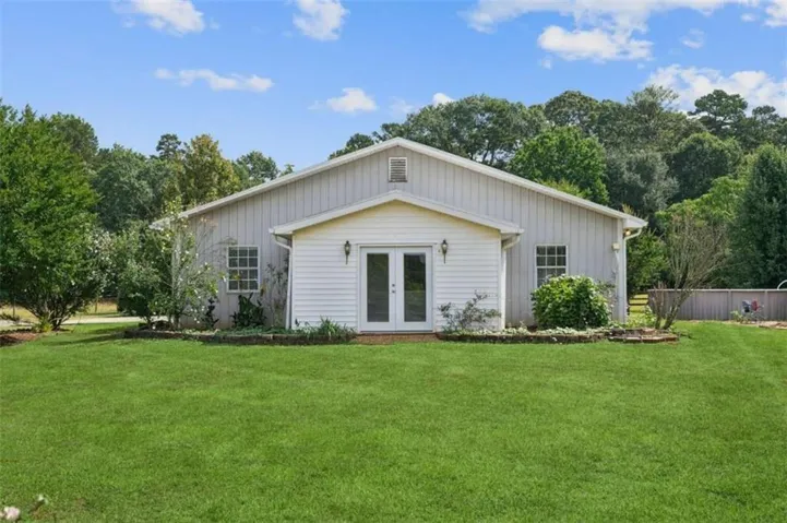 Rear view of property featuring french doors and board and batten siding