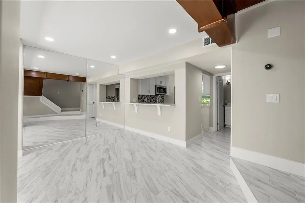 Open living and dining areas  featuring recessed lighting,
