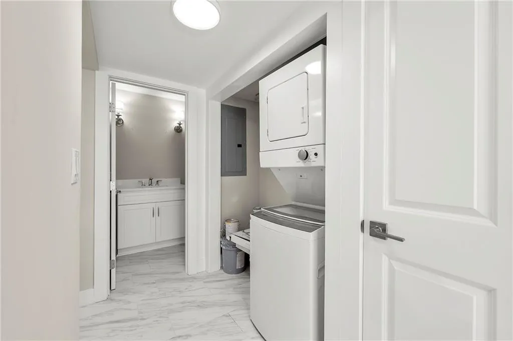 Laundry with stackable washer and dryer included.