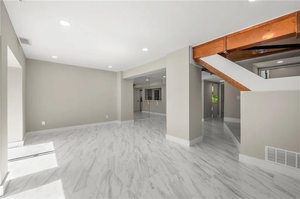 Another view of living room with recessed lighting
