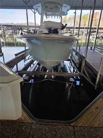 Dock area featuring boat lift and a water view