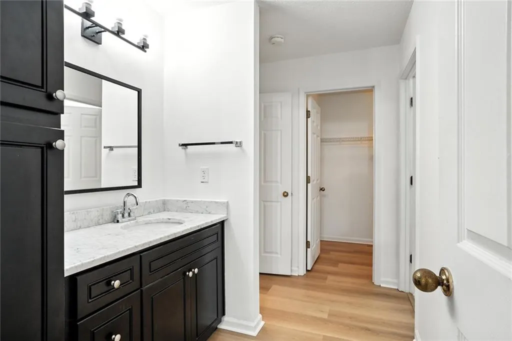Bathroom featuring vanity and wood finished floors