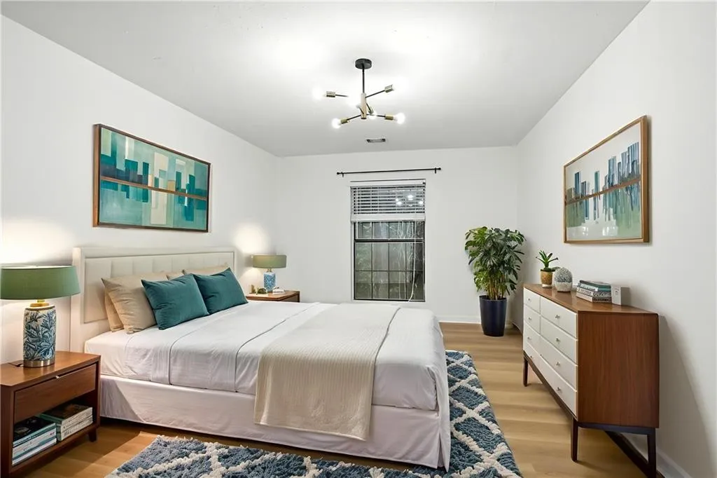 Bedroom with light wood-style floors and a chandelier