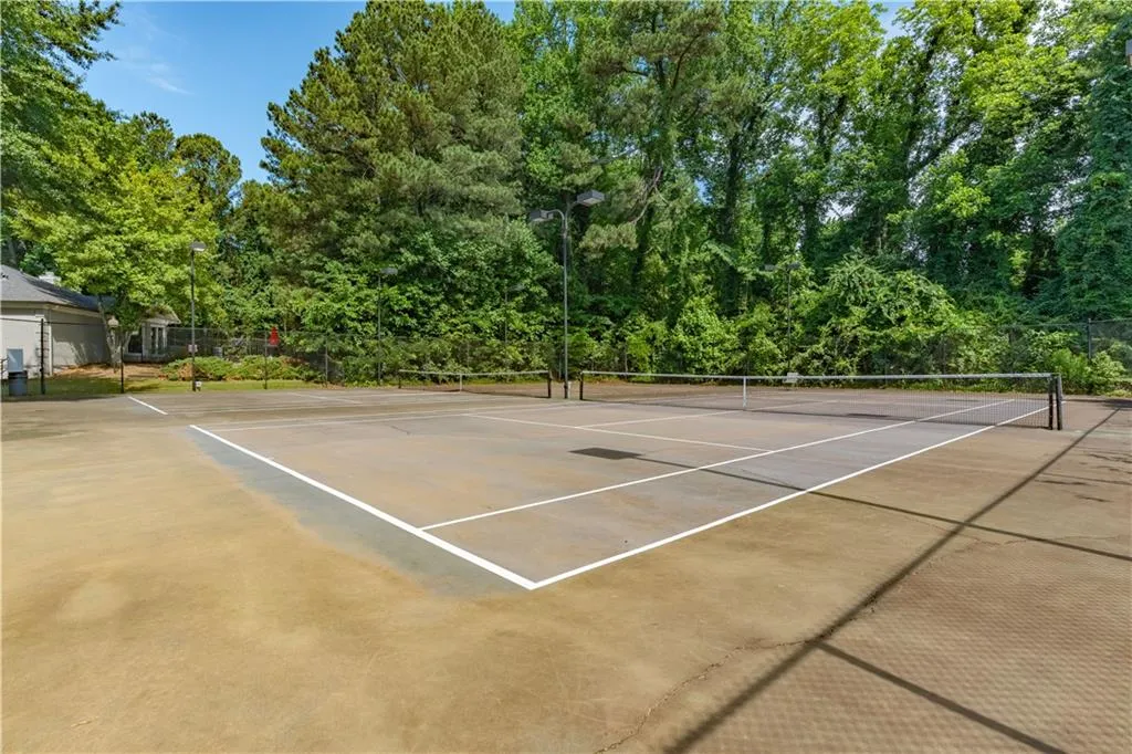 View of tennis court with community basketball court