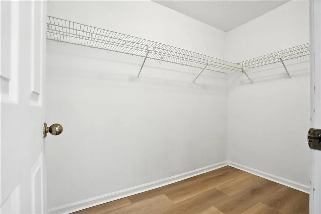 Walk in closet featuring wood finished floors
