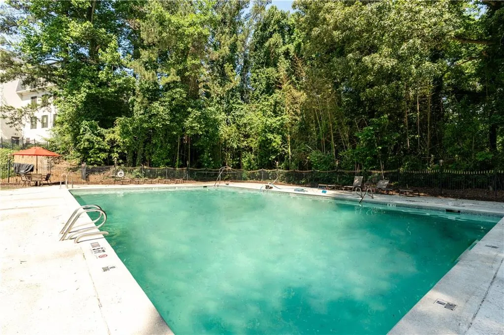 Community pool with a patio
