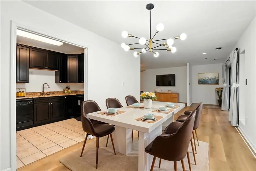 Dining room with a chandelier and light wood-type flooring