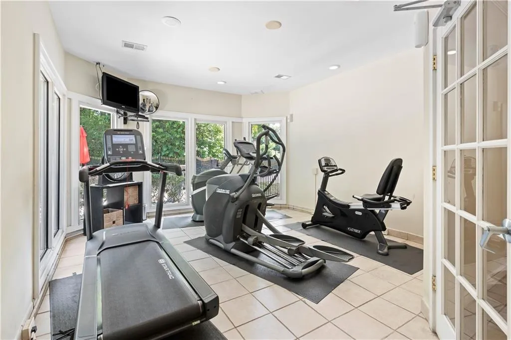 Exercise room featuring recessed lighting and tile patterned flooring