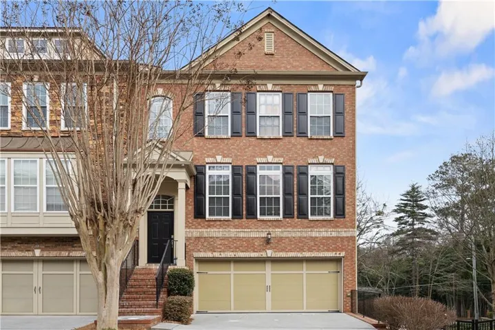 View of front of home with brick siding and driveway