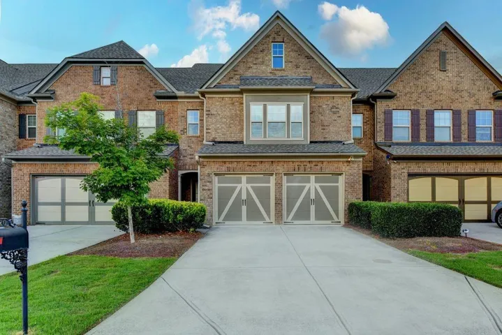 Brick exterior townhome with multiple gables and dormer windows