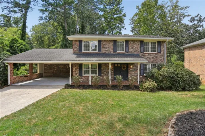 Beautiful Traditional Brick Home with Stunning Sunroom on a Private Wooded Lot in Tucker!