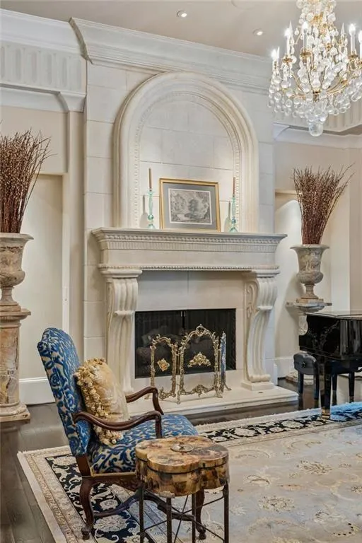 A hand-carved limestone fireplace anchors the formal living room.