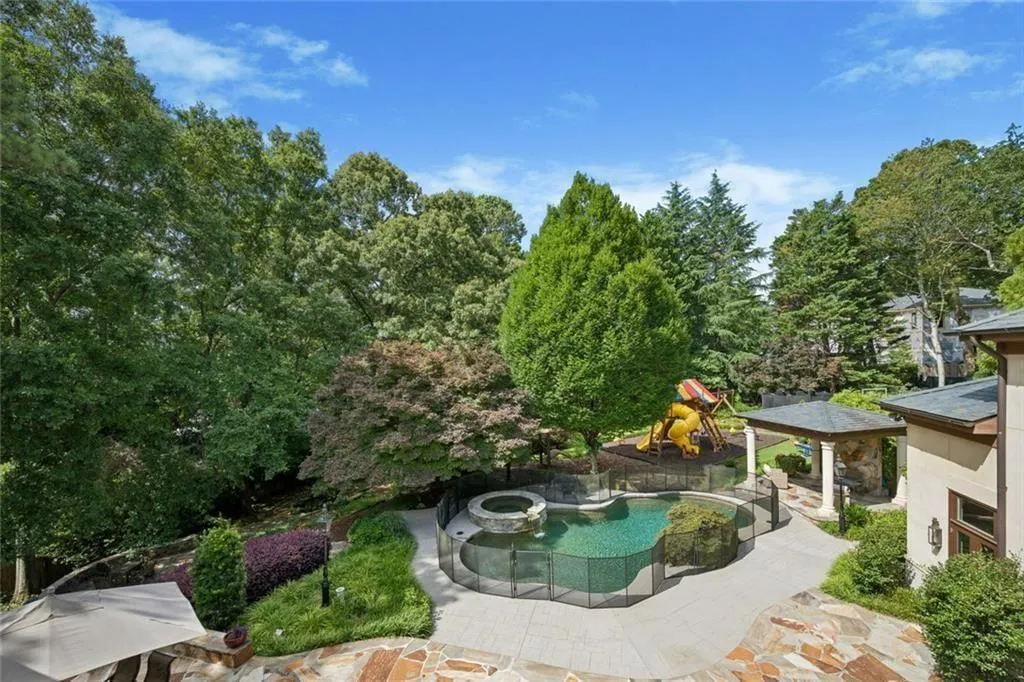 A private, tree-lined backyard with a pool, spa, and play area — total seclusion in the middle of  the city.