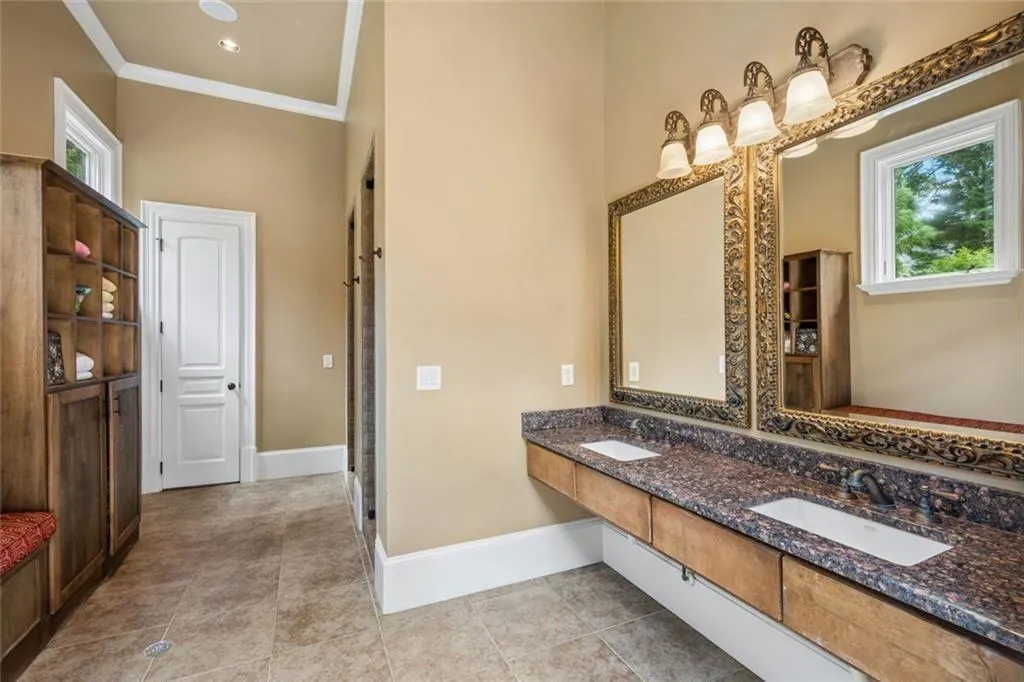 A pool house changing room with double vanities and built-in storage — thoughtfully designed for everyday convenience.