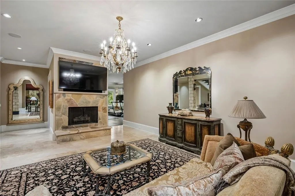 Another angle of the terrace-level family room — warm, layered, and open to the home gym beyond.