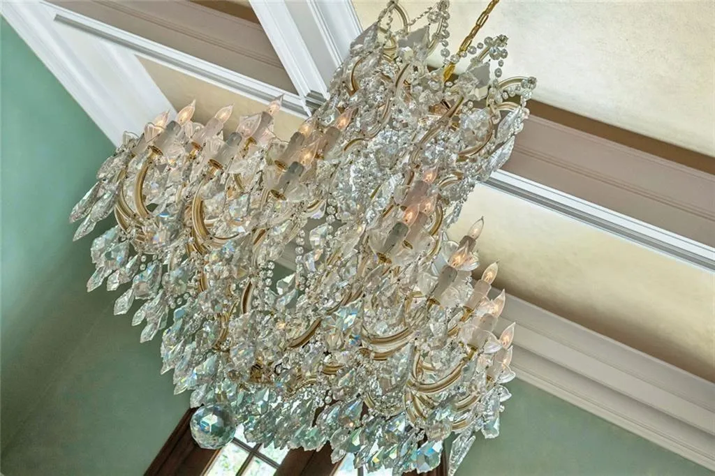 A breathtaking crystal chandelier centers the dining room.