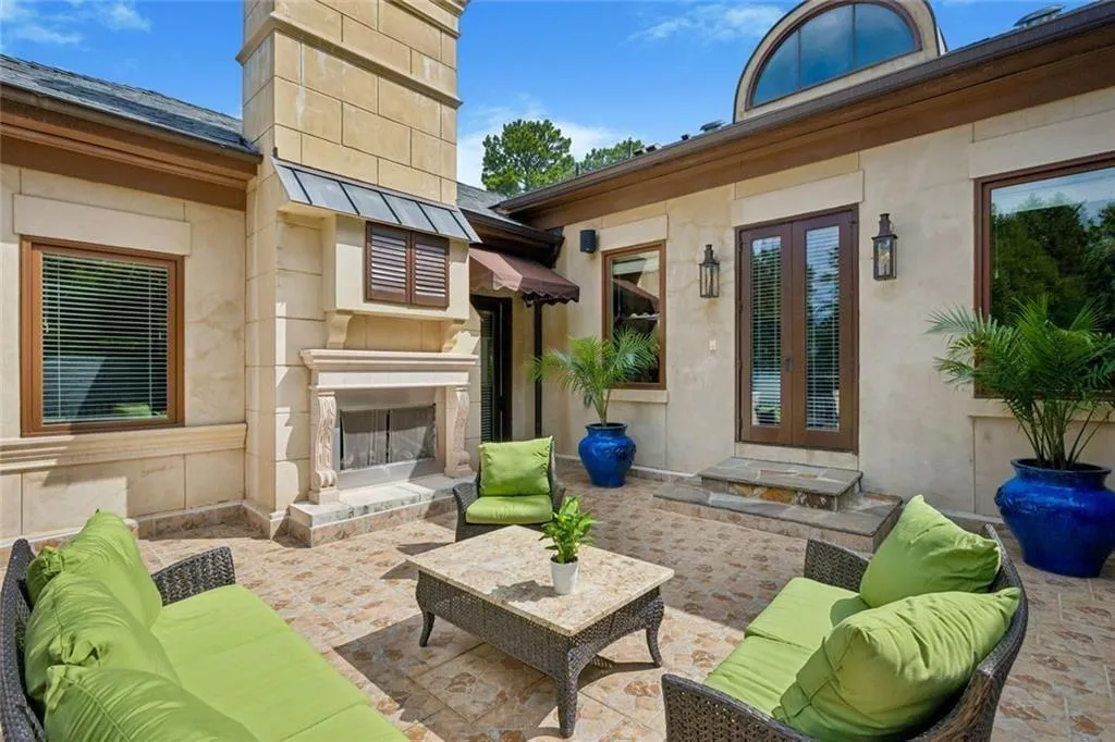 A private second-story patio with an outdoor fireplace — a secluded retreat above it all.