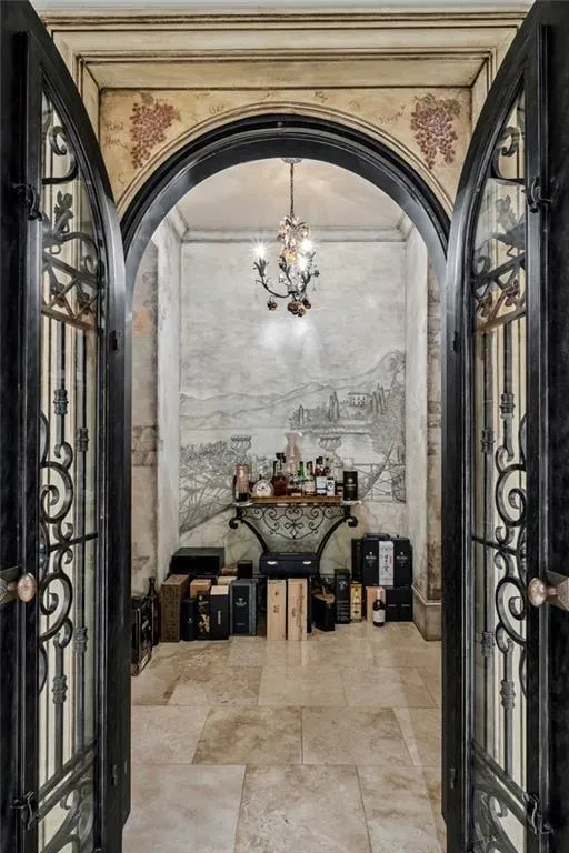 A private wine cellar  behind wrought-iron doors — hand-painted murals.