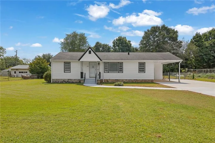 White siding exterior with black trim accents