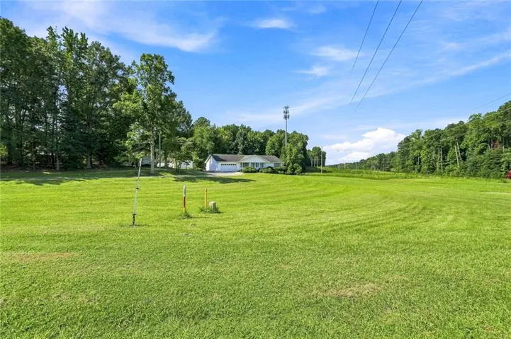 Expansive green lawn with a visible structure in the distance