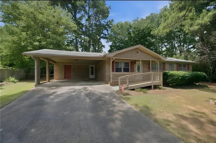 Ranch-style exterior with brick siding and a covered carport