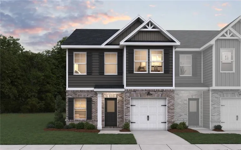 Two-story residence featuring a brick and siding facade, an attached single-car garage, a covered entry, and a gabled roofline with decorative trim